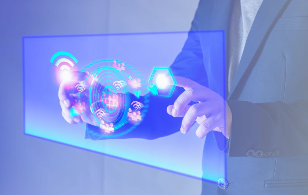 image | Digilite | Web Design Company in Glendale CA Person interacting with a glowing blue holographic digital network interface.