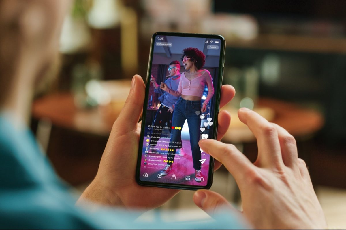 image | Digilite | Web Design Company in Glendale CA Close-up of a person watching a short-form vertical dance video on a smartphone.