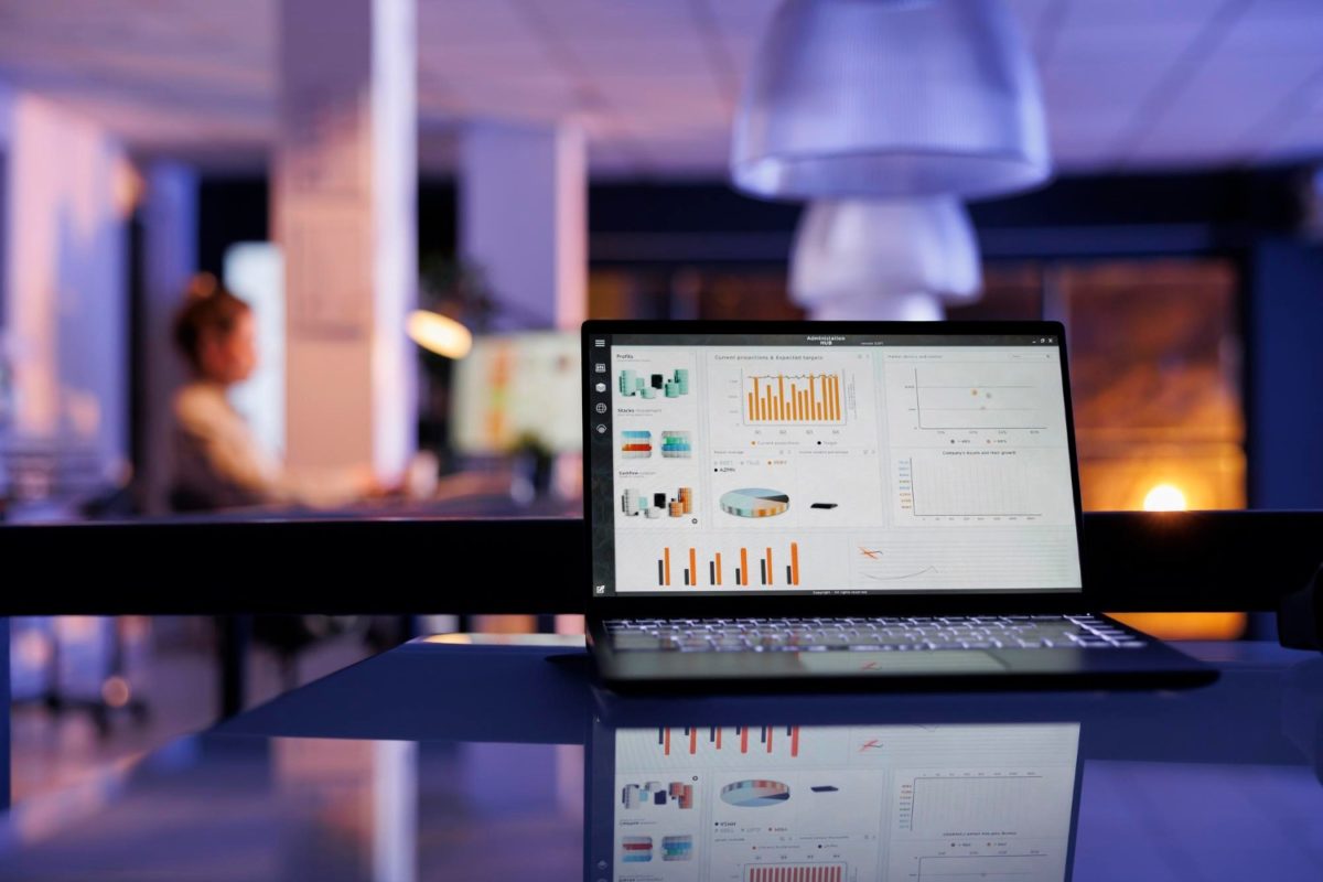 image | Digilite | Web Design Company in Glendale CA A laptop screen displaying a marketing data dashboard with performance charts and business growth metrics in a modern office setting.